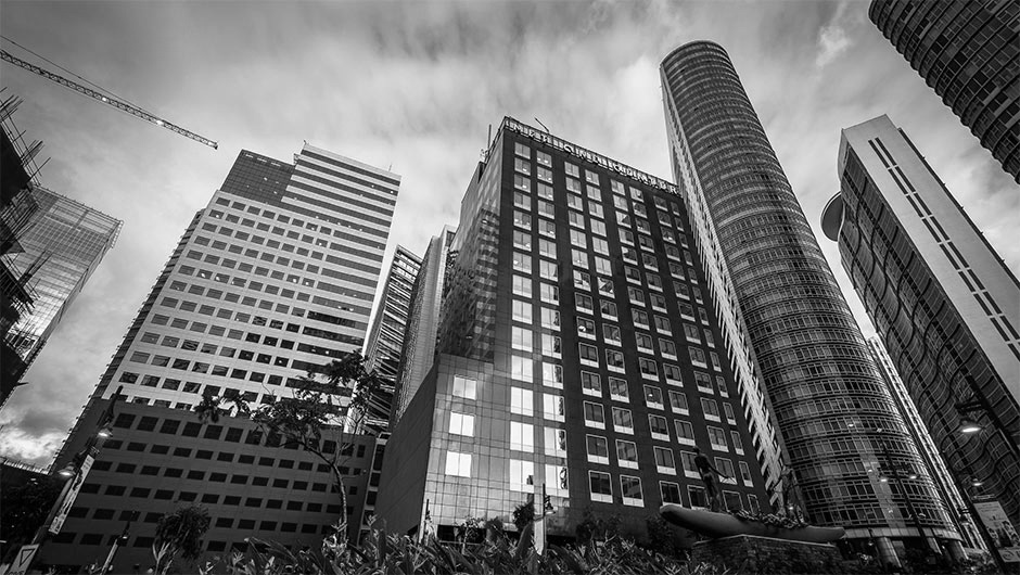 Modern skyscrapers in Manila’s business district under a vibrant evening sky.