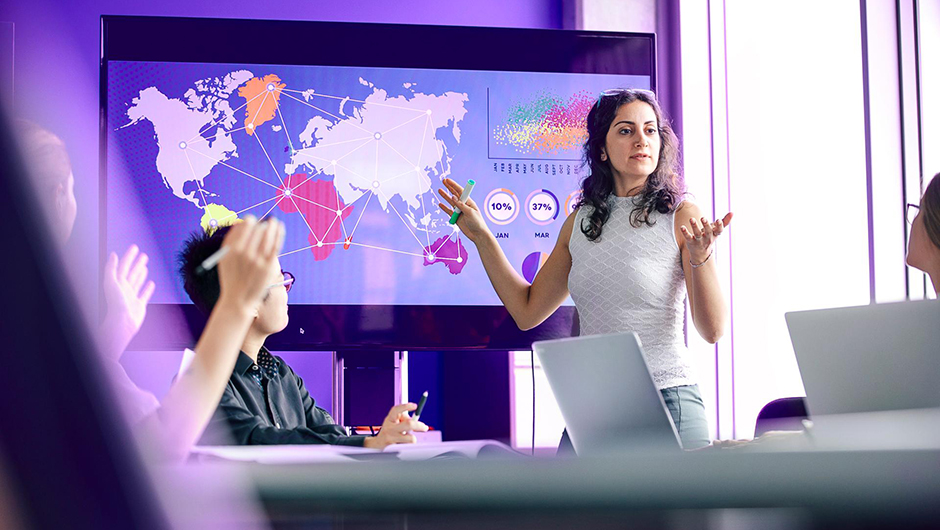 Business presentation with global data analytics, world map visualization, and collaborative team discussion.