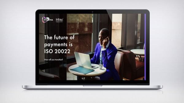 The future of payments is ISO 20022: Africa edition report Man on phone in front of computer at table