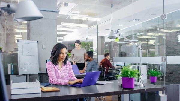 Partnering on commercial lending opportunities Woman with laptop in office