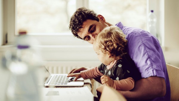 Three Reasons the Mortgage Industry is Embracing eClosing Man with baby on laptop