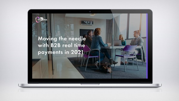 Moving the needle with B2B real-time payments in 2021 Image of laptop with people in office at table