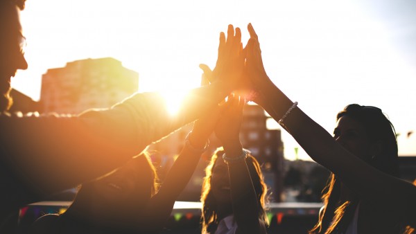 How banks can go to market and reinvent payment experiences with ecosystem partners Image of group high-five