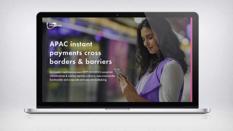 Image of laptop with woman on phone