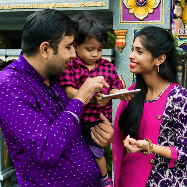 Indian couple with child using tablet