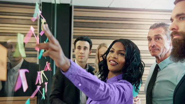 Woman pointing at post-it