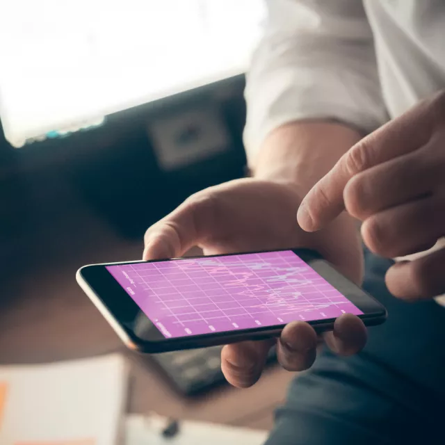 Business man uses purple tablet with graph