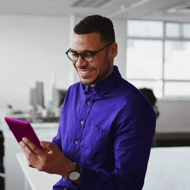man looking at phone happily
