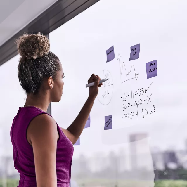 woman standing at whiteboard