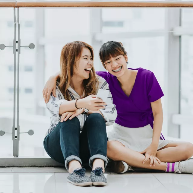 friends laughing sitting on the floor