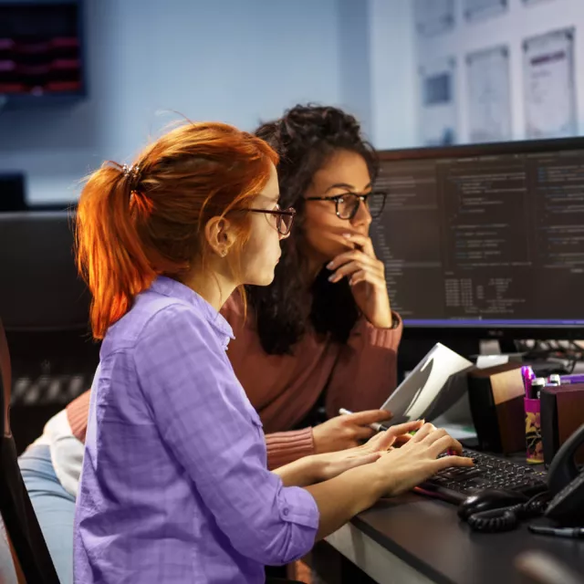 two women looking at computer