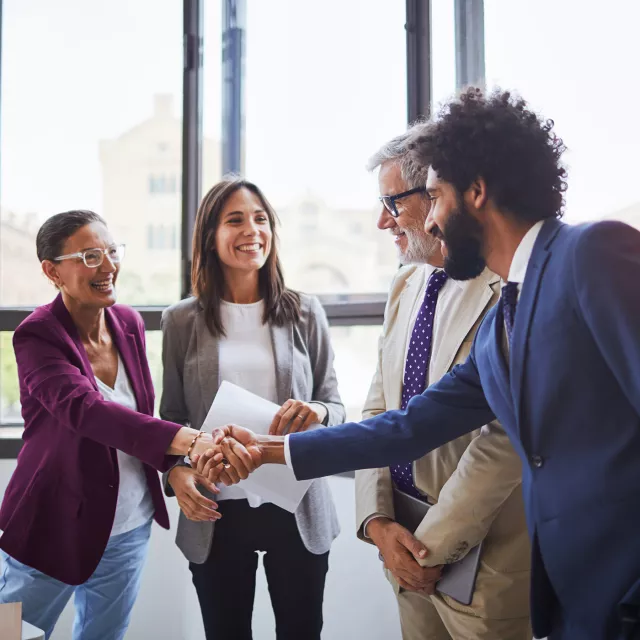 Image of officemates congratulating each other