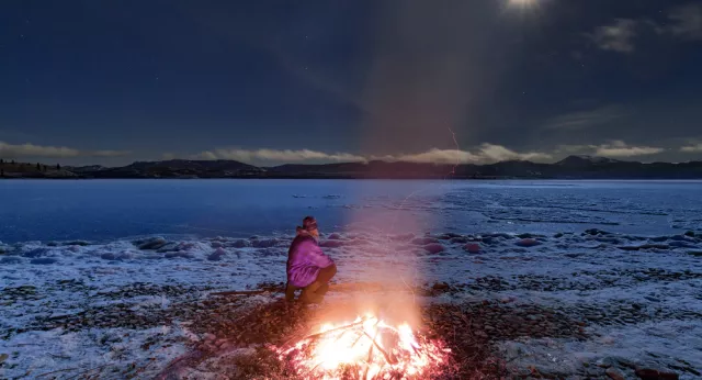 Person sitting by firepit