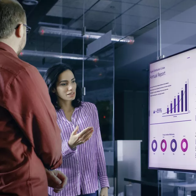 Image of woman presenting graphs to team