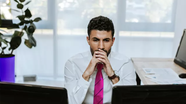 Man looking at computer screens