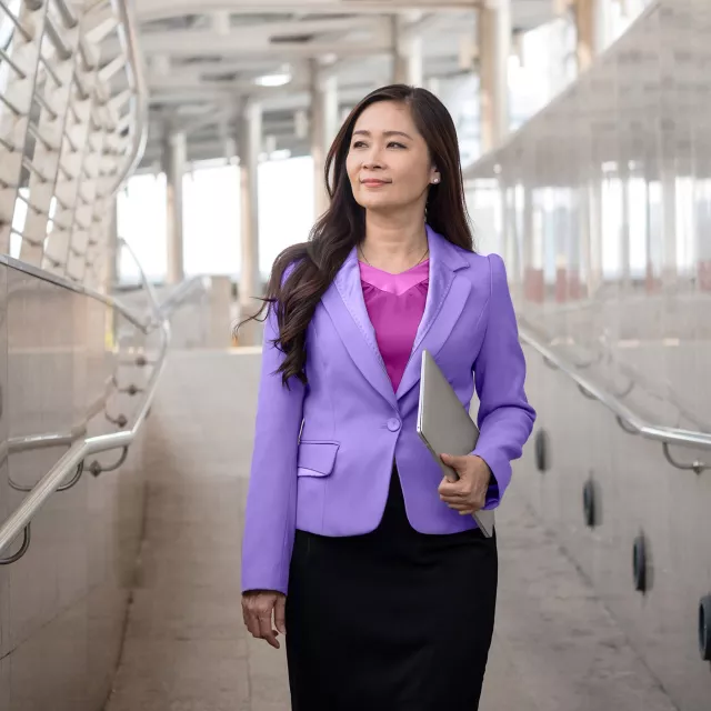Image of woman walking down a hallway