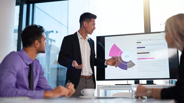 Image of team discussing a graph