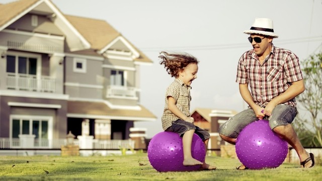 Image of father and daughter playing outside
