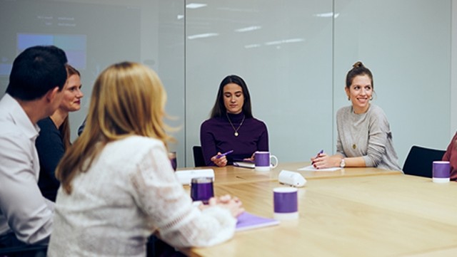 Image of team discussing in a meeting room