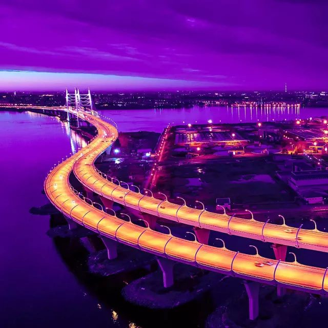 Image of lighted bridge over urban waters at dusk
