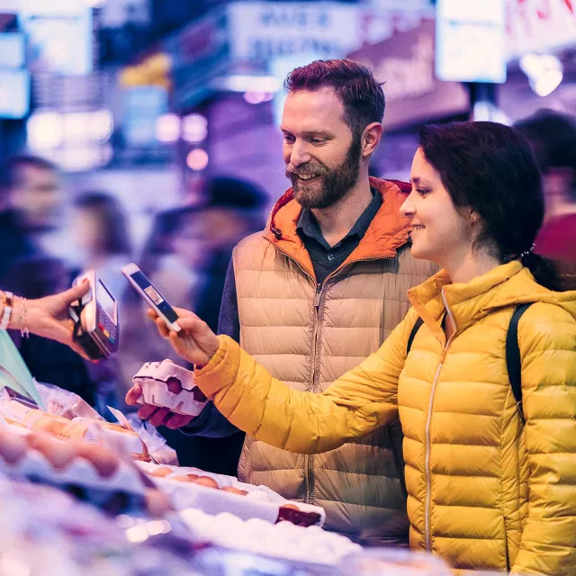 Image of man and woman paying digitally