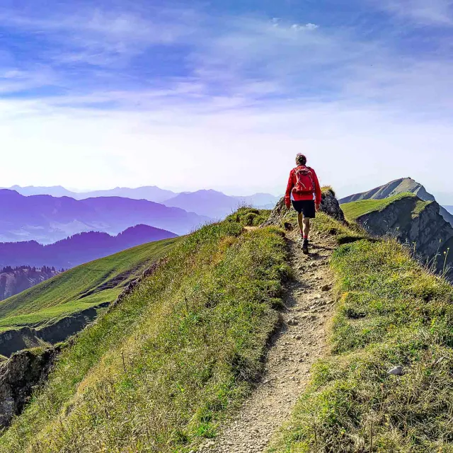 Image of man trekking on top of a hill