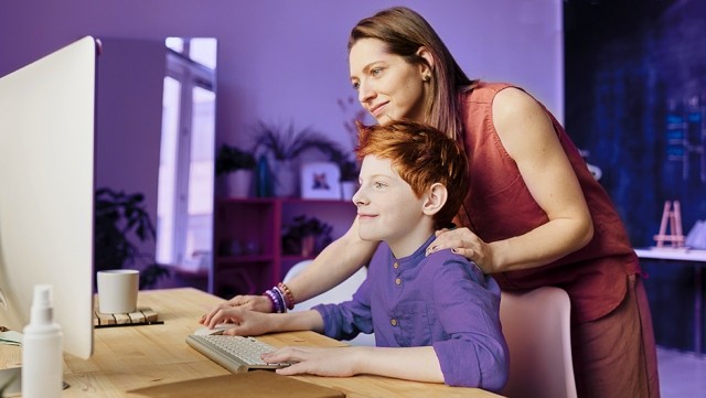 Image of mother and child using computer