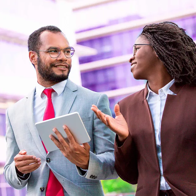 Image of man and woman discussing outside office