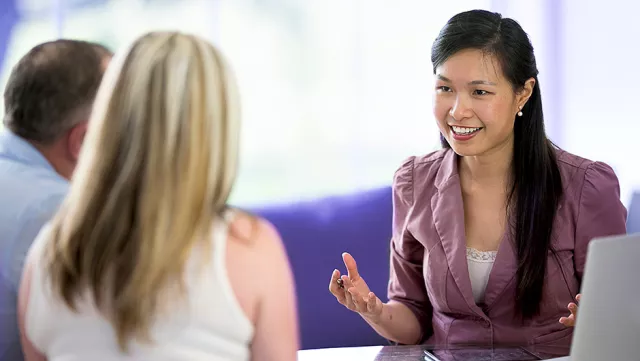 Image of woman talking with two clients