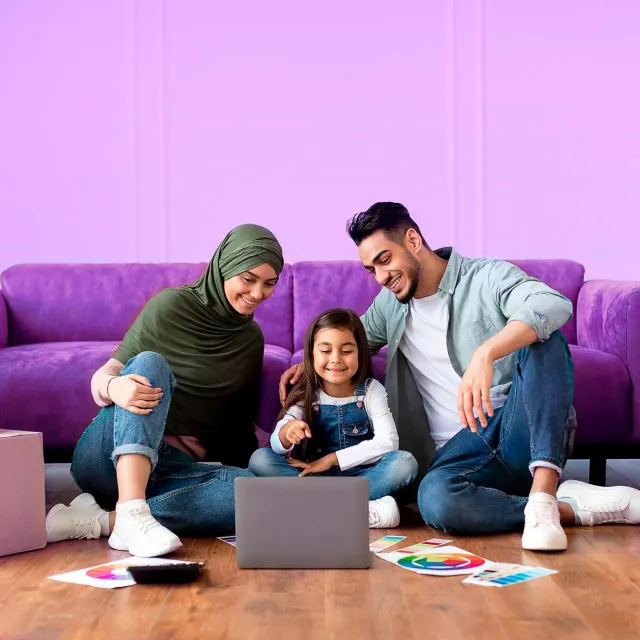 Image of parents and daughter smiling at a laptop