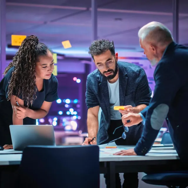 Image of officemates discussing around a table