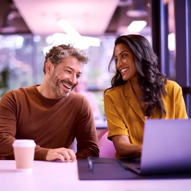 Two persons talking at the office