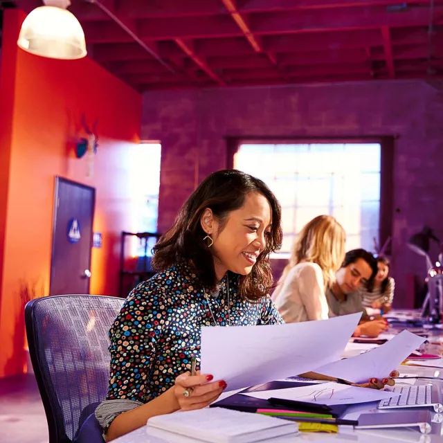 Image of woman sorting papers in an office