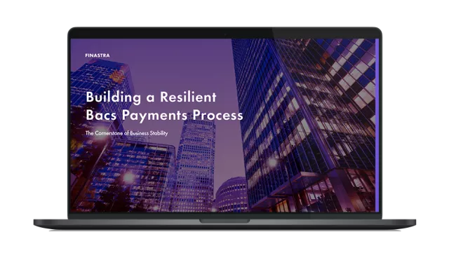 Image of laptop with cover slider of "Building a resilient Bacs payments process: The cornerstone of business stability" eBook