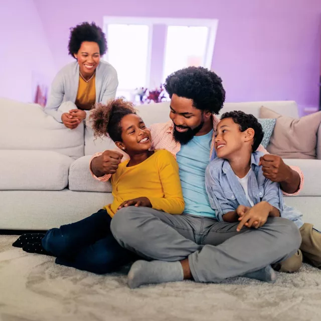 Image of a happy family in the living room