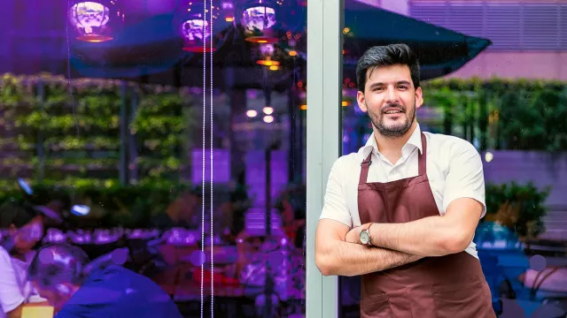 Image of business owner standing outside a building