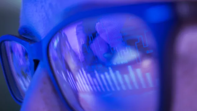 Image of graphs reflected on eyeglasses