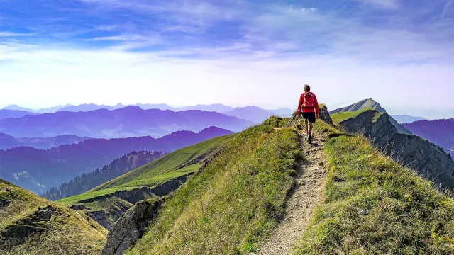 Image of hiker on top of a mountain path