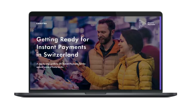 Image of laptop with cover slide of "Getting Ready for Instant Payments in Switzerland" ebook