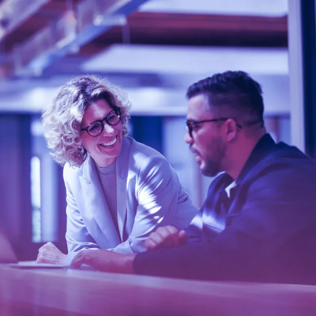 Image of woman and man discussing while seated
