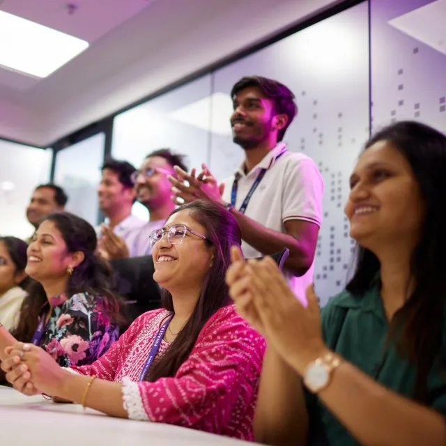 Image of officemates clapping