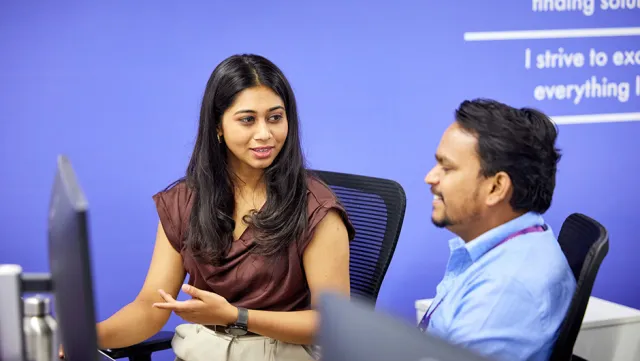 Image of woman and man discussing while seated