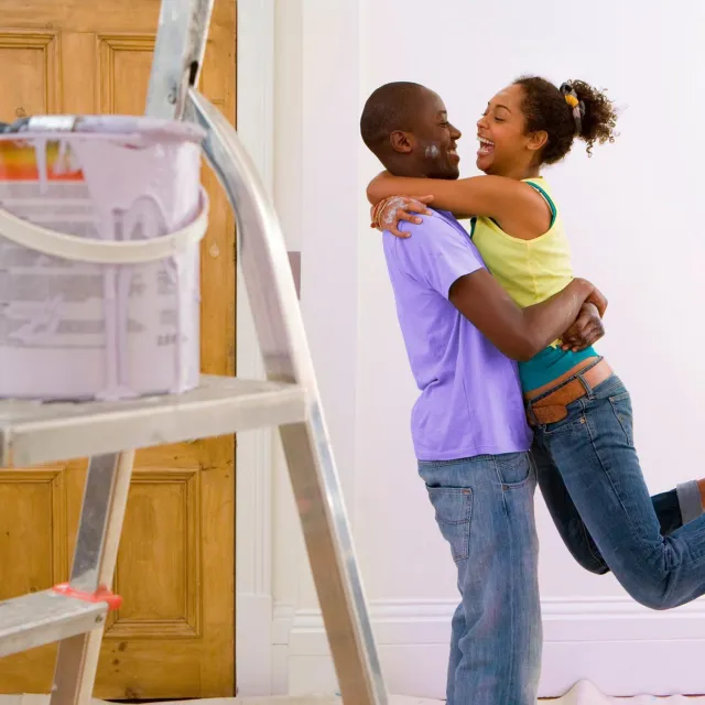 Image of couple in the middle of painting a room
