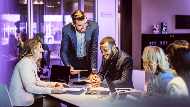 Modern business meeting with professionals collaborating in a corporate office.
