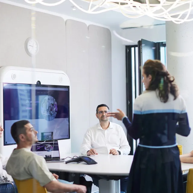 Image of team discussing in a meeting room
