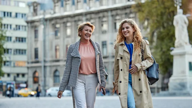 Image of two women walking and talking outdoors