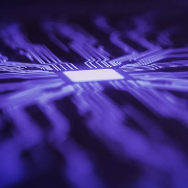 Abstract close-up of a glowing microchip with purple circuit lines symbolizing artificial intelligence and advanced computing technology.