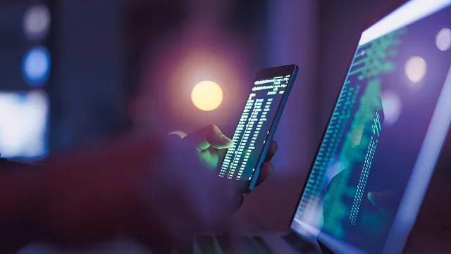 Image of hand holding and using a mobile phone