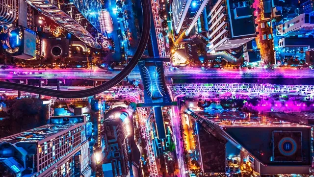 Vibrant aerial view of a futuristic city with neon lights.