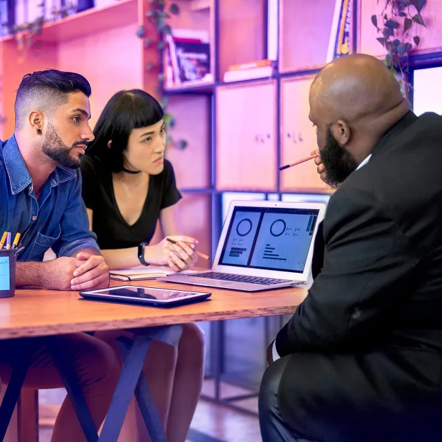 Image of couple listening to a presentation